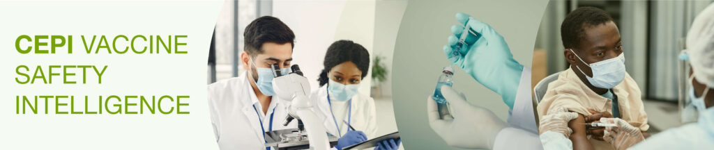 two medical scientists in lab coats and masks examine a specimen. Gloved hands to the left insert a syringe into a medicine vial.