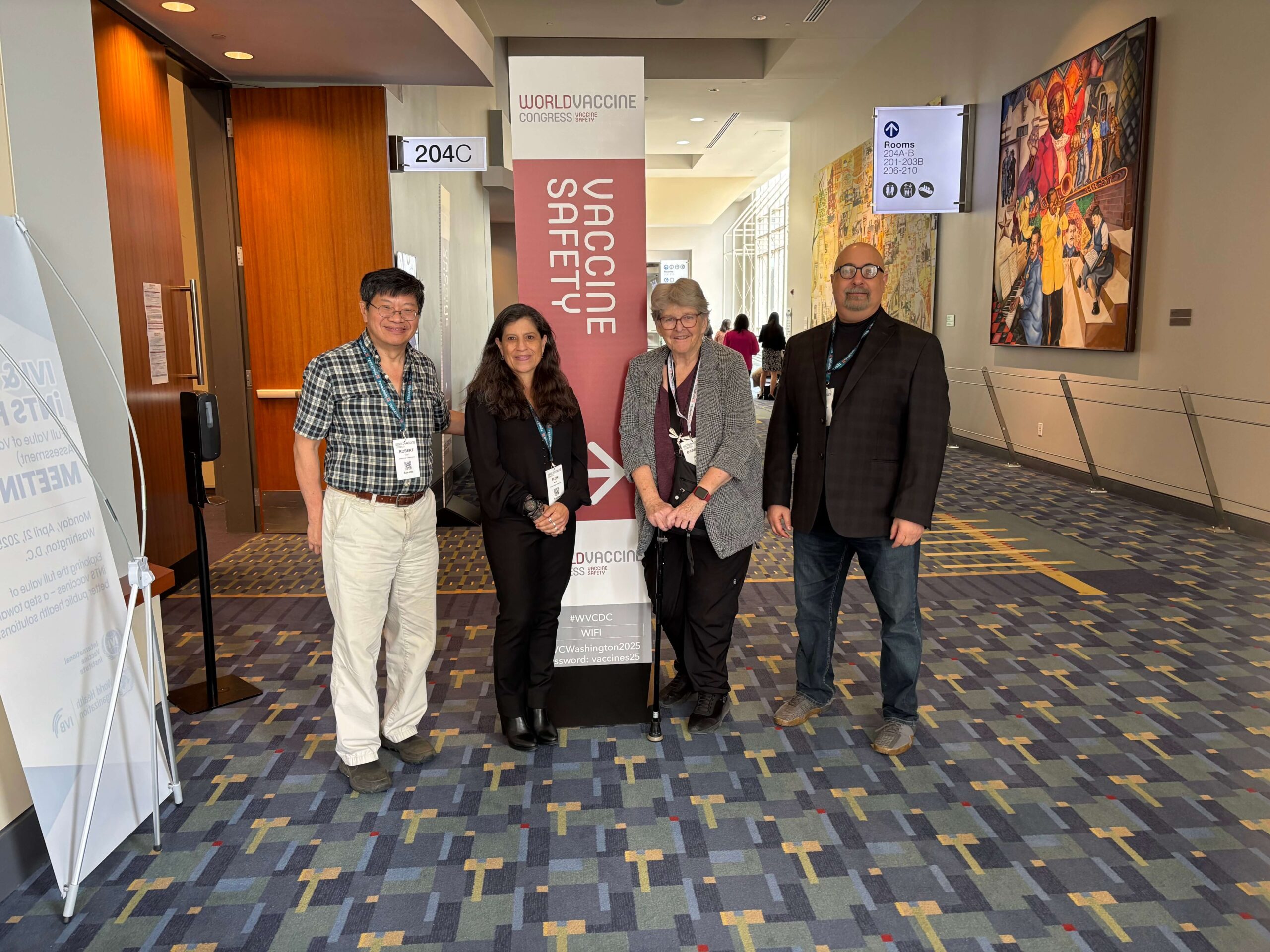 Four adults stand next to each other at the 2025 World Vaccine Congress